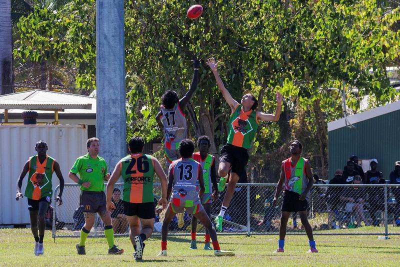 Two men jump for the ball during a football game.
