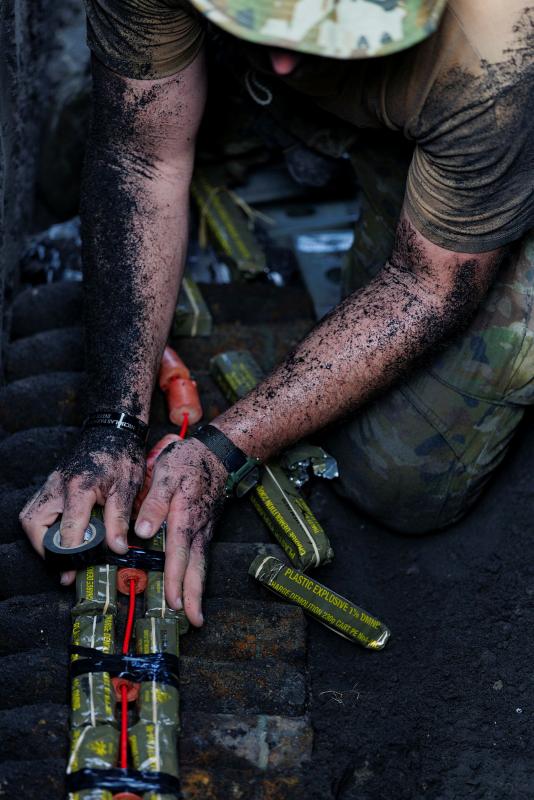 An Australian Army Explosive Ordnance Disposal technician on Operation Render Safe 26 prepares a charge to destroy unexploded ordnance in Rabaul, Papua New Guinea.