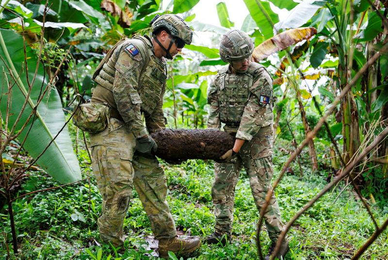 Explosive Ordnance Technicians, Australian Army Corporal Nariah Vale and British Army Corporal David Nicholls remove a 100lb bomb from a community in East New Britain, Papua New Guinea during Operation Render Safe.