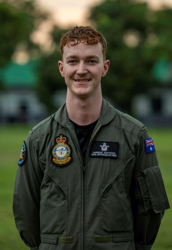 A male military member outside. 