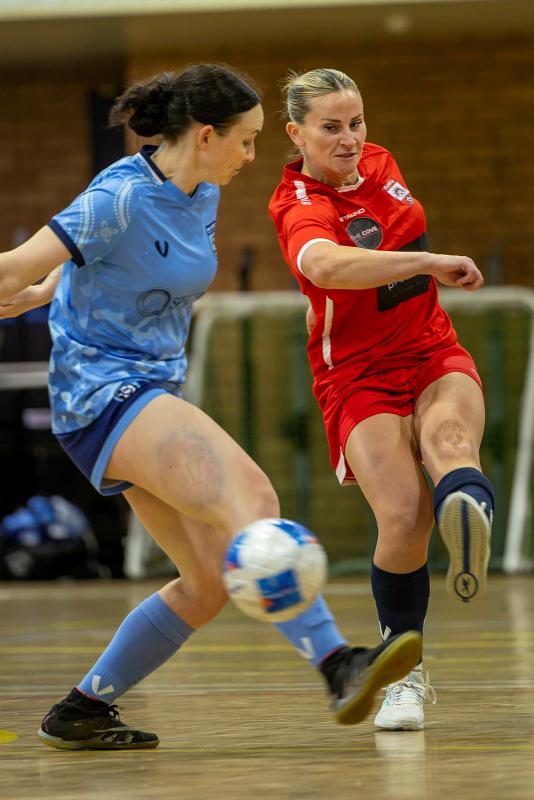 Leading Seaman Britanny Rollason (r) kicks the ball past Leading Aircraftwoman Sarah Birrer (l) during the ADF Futsal Championships at Randwick Barracks.