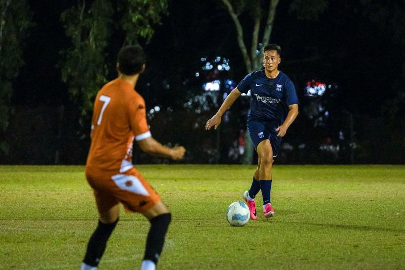 Two men play football.