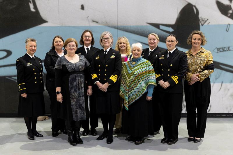 A group of women standing together posing for the camera.