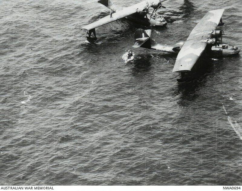 A black-and-white historical photo of two aircraft in the ocean.