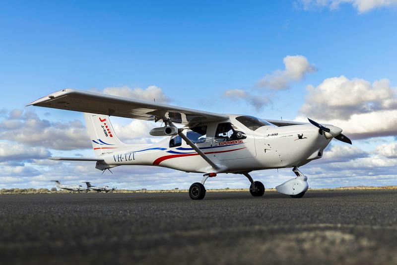 A light aircraft on the tarmac at an airport.