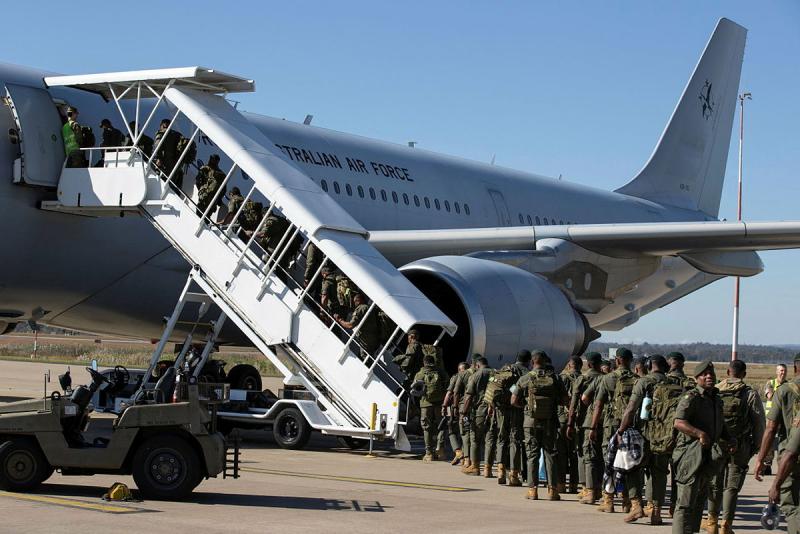 Soldiers line up to board an Australian aircraft.