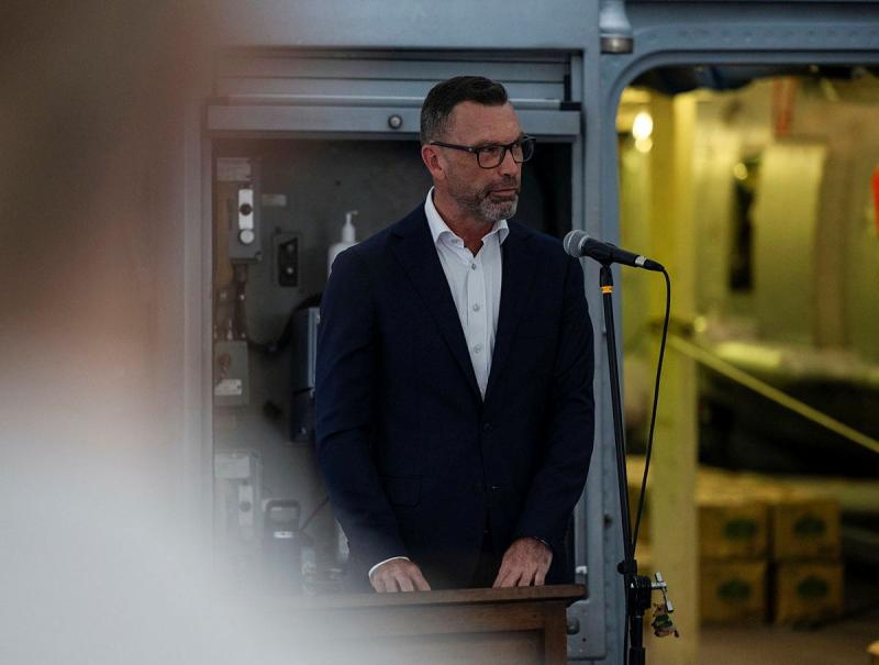 An Australian diplomate talks to guests aboard HMAS Perth.