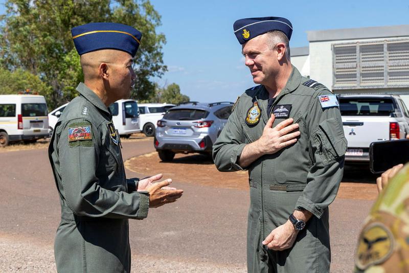 Two military men engage in conversation.