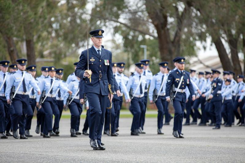 Military members march in formation.