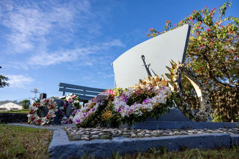 A memorial with wreaths laid on top.