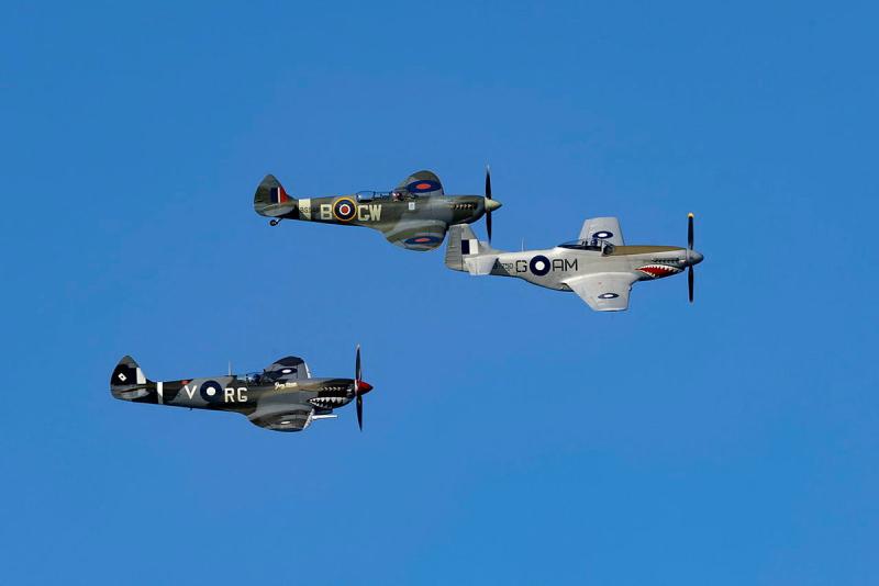 Three military aircraft fly in formation.