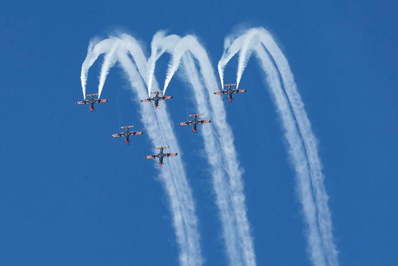 Six aircraft performing a flying display in the air.