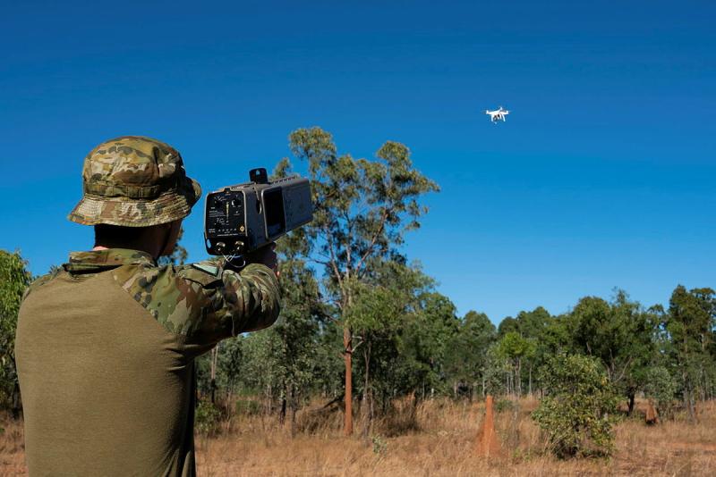 An Australian soldier aims his launcher at a drone.