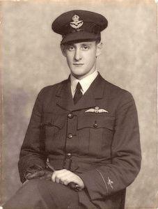 A black and white shot of a seated military member.