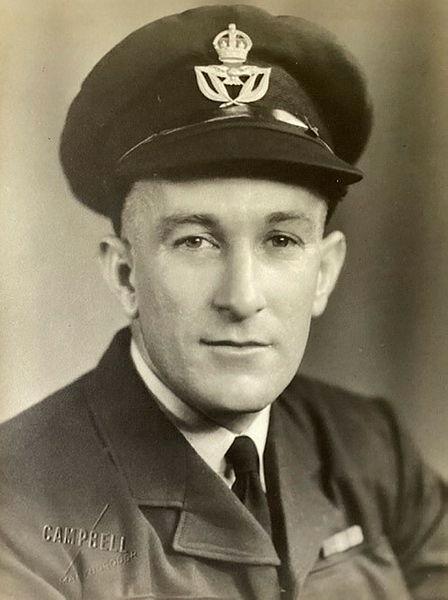 A black and white close-up of a male military member's face.