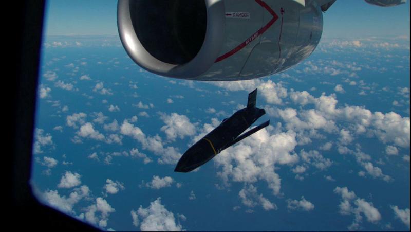 A missile is dropped from an aircraft in the sky.