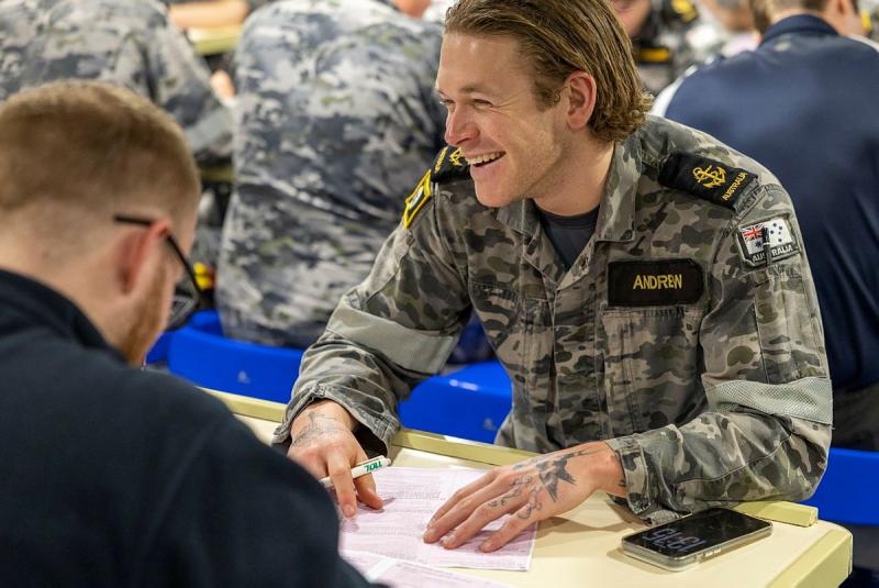 A sailor completes a survey.