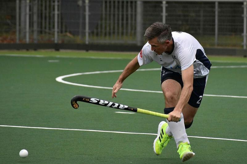 A man tracks a hockey ball during a game.