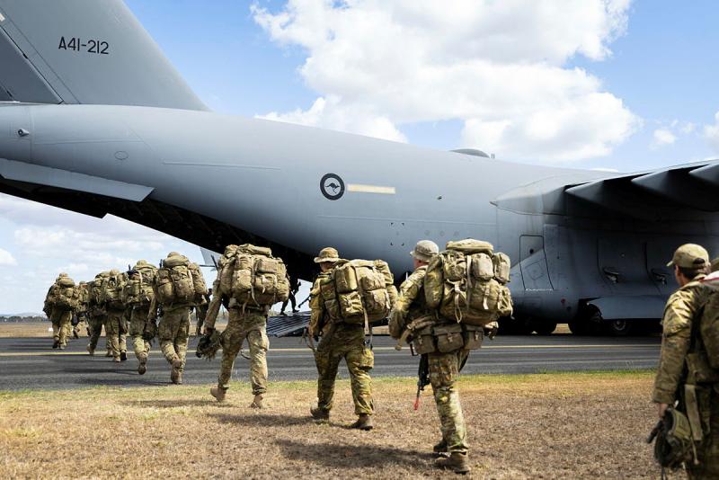 Australian Army soldiers disembark off a Royal Australian Air Force plane.