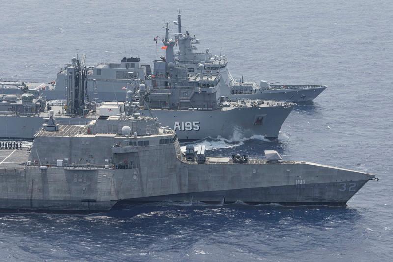 Three ships sail close together.