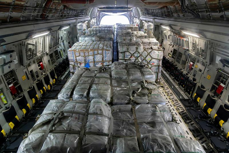 Several large pallets are secured inside an aircraft.