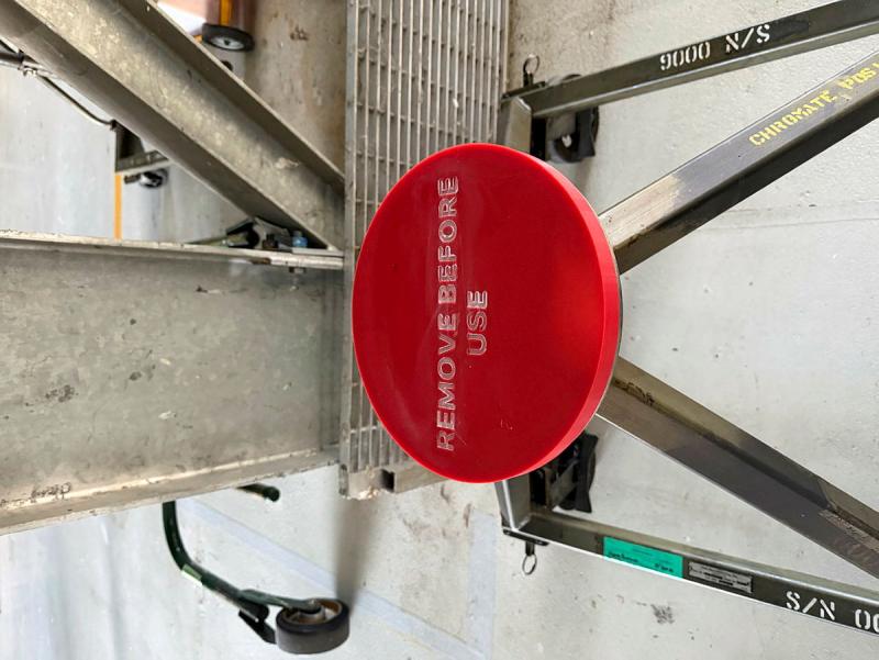 A red, round cover that reads 'REMOVE BEFORE USE'.