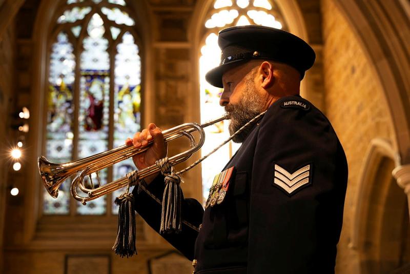 A military member plays the trumpet in a church.