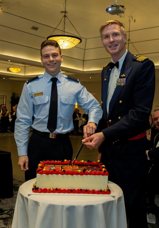 Two military men cut a cake.