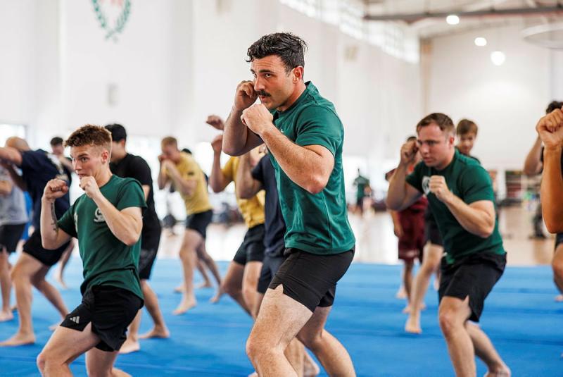 Three Army personnel are shaping up to punch during their Muay Thai training.