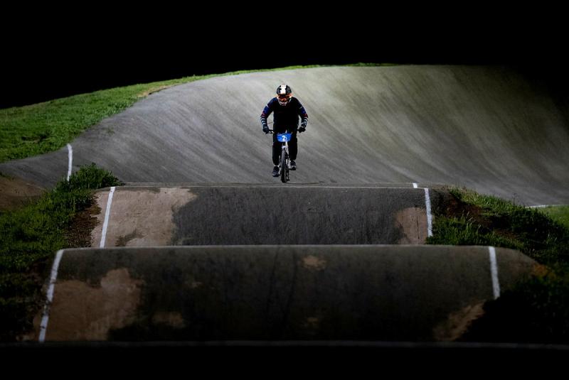 A cyclist prepares to ride on a section of road that has two dips in it