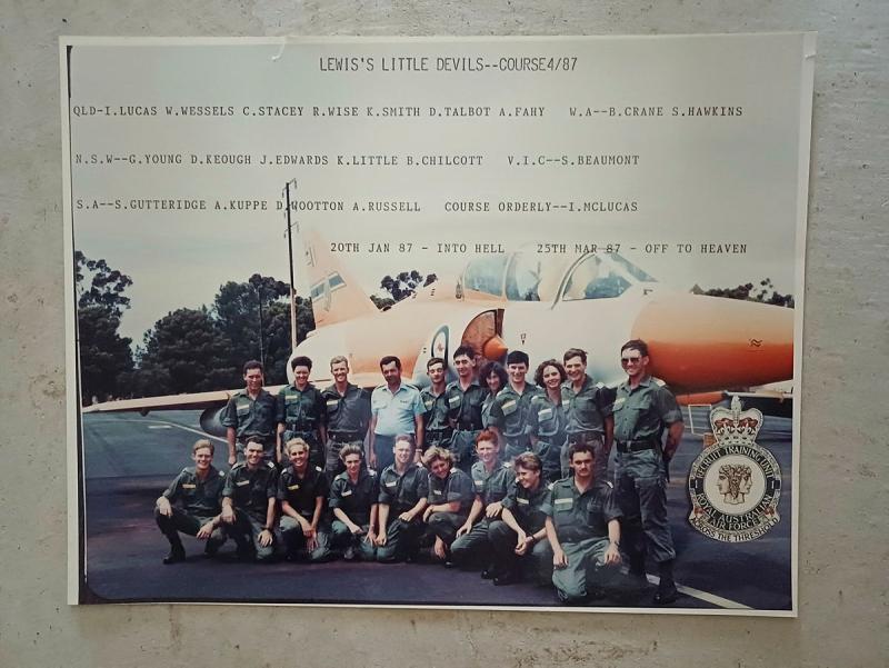 A photo of a photo of military members in front of an aircraft.