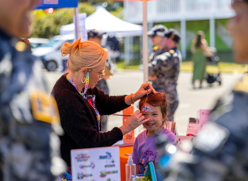 A child has her face painted.
