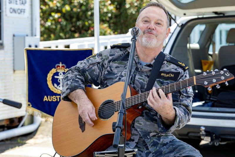 A sailor plays the guitar