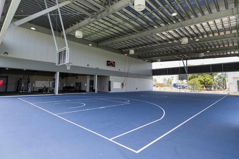 An empty blue basketball court.