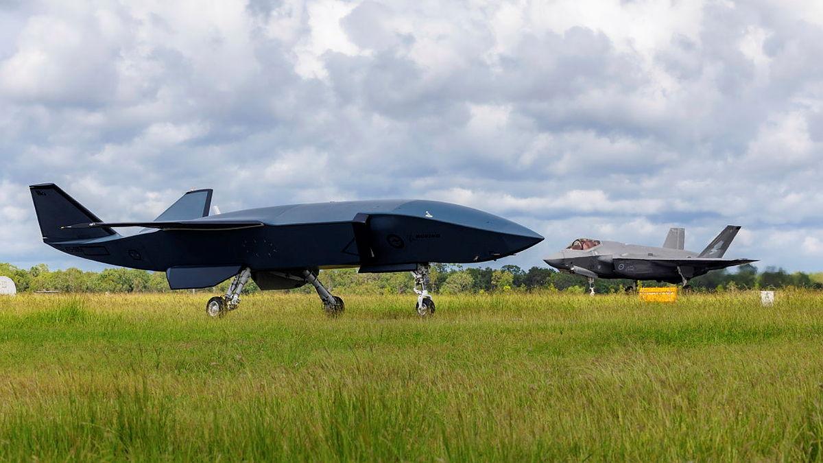 A black aircraft on the runway.