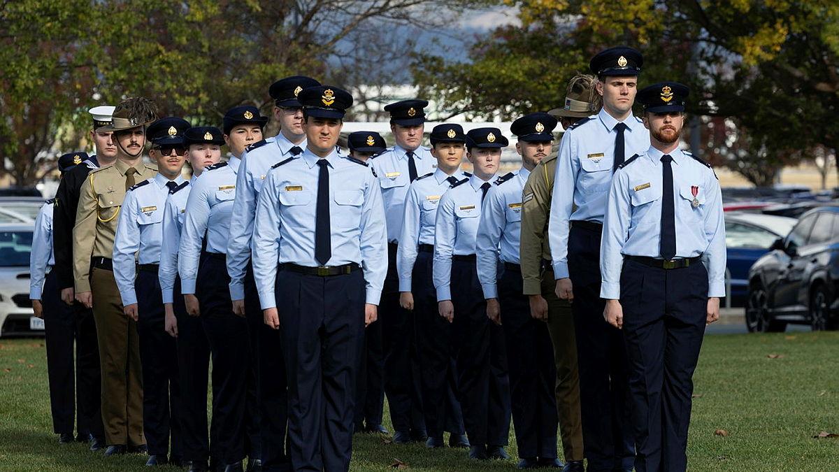 A group of people in Air Force uniform stand to attention.