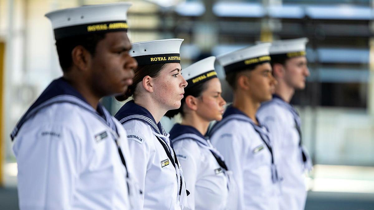 Five sailors stand in a row.