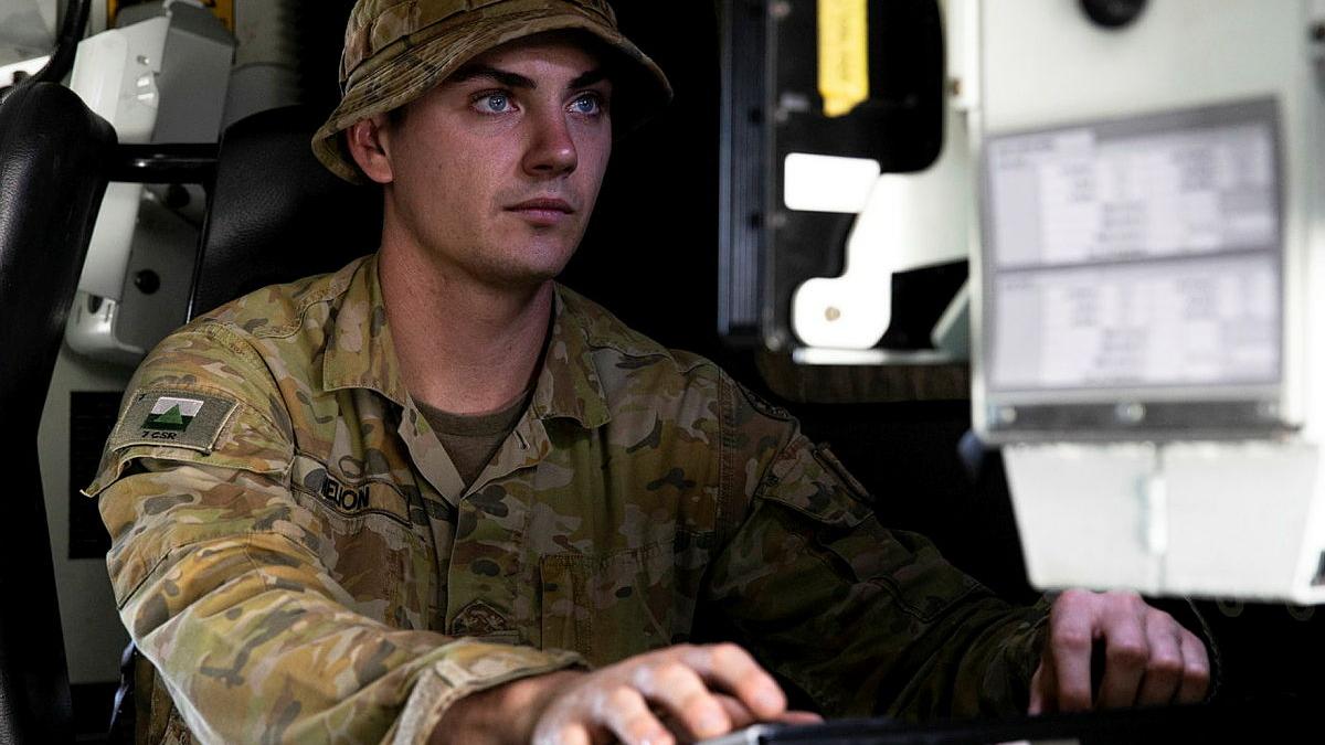 Corporal Max Helion, of 7th Combat Signal Regiment, prepares the communication systems on a Bushmaster Protected Mobility Vehicle during Exercise Mercury Run.