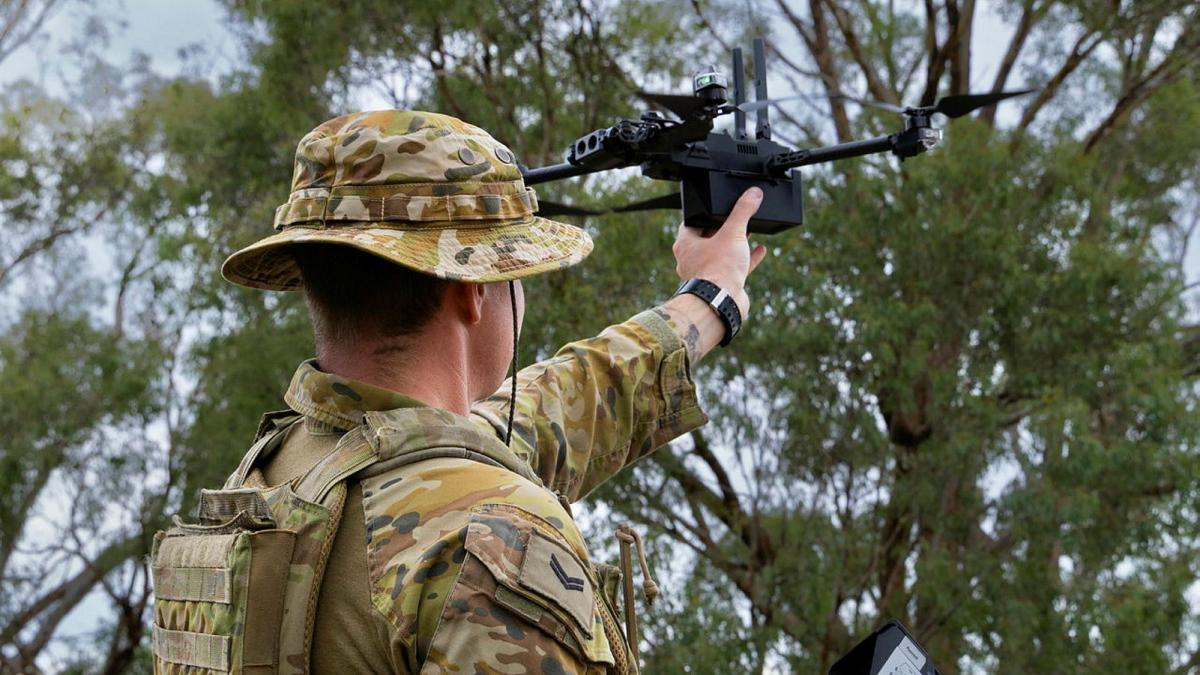 Corporal Henry Laurie catches a drone at Puckapunyal Military Area.