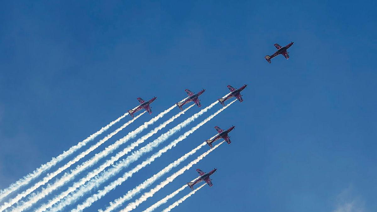 Six aircraft flying in the air leaving behind white smoke trails.
