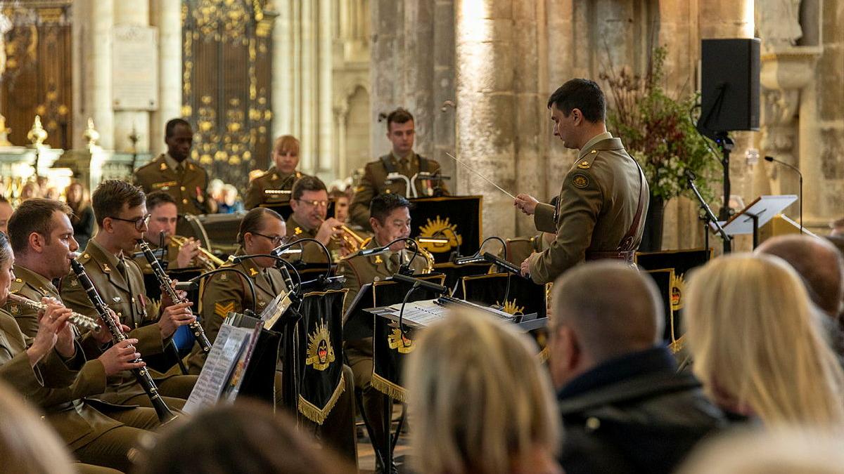 Major Doug Hall from the Australian Army Band conducts the band in the Cathédrale Notre-Dame d'Amiens, France.