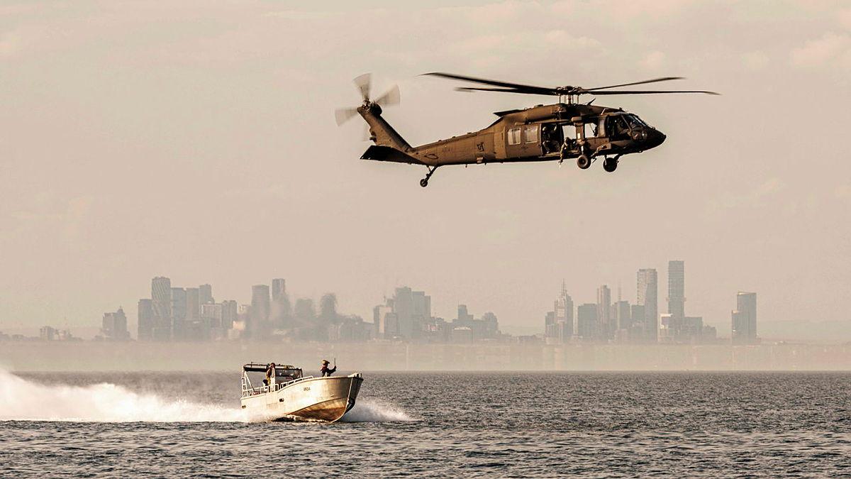 An Australian Army UH-60M Black Hawk prepares to conduct a casualty transfer with a practice dummy during Exercise Nemesis Typhoon in Port Phillip Bay, Victoria.