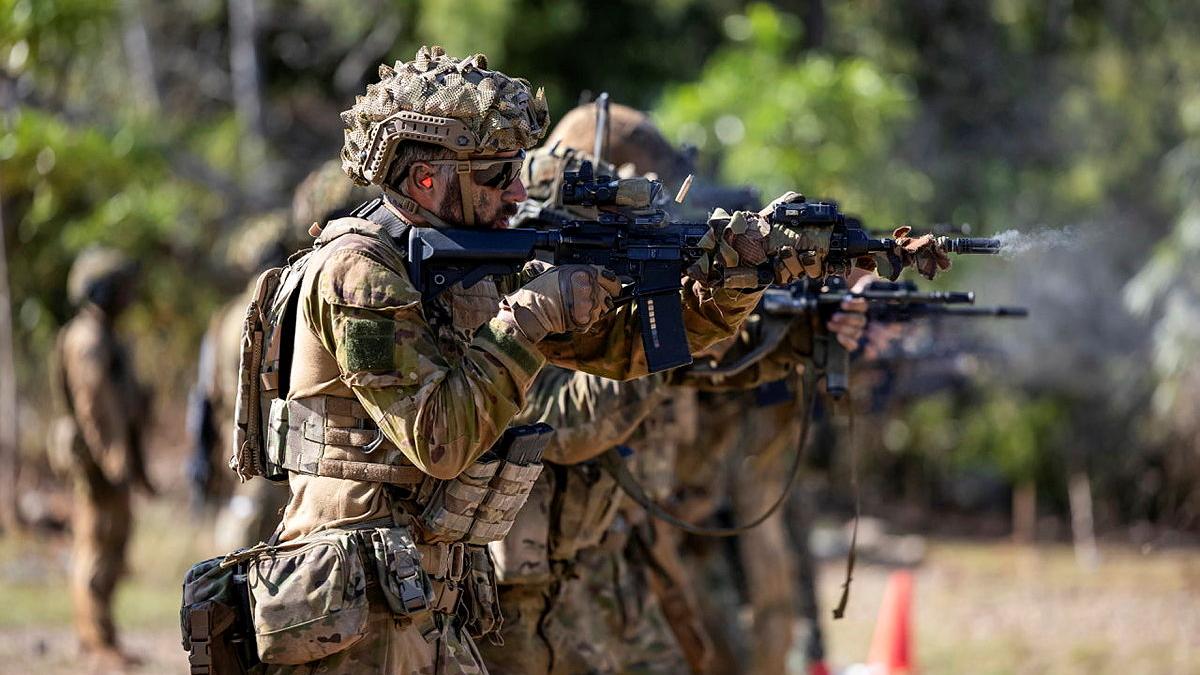 Soldiers fire weapons.