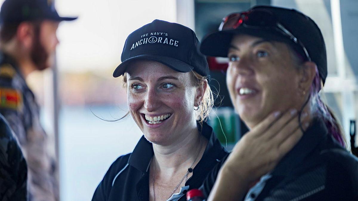 Two woman smile on a boat.