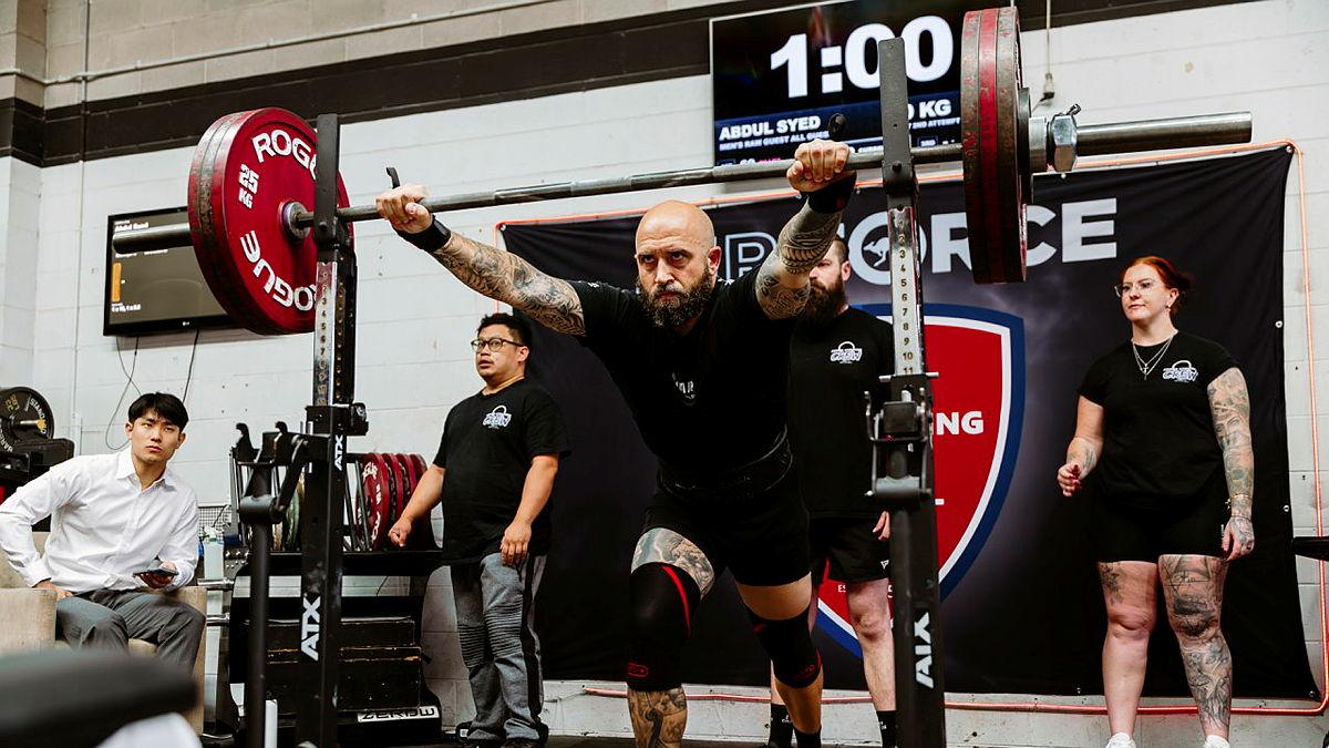 A man prepares to lift a weighted bar.
