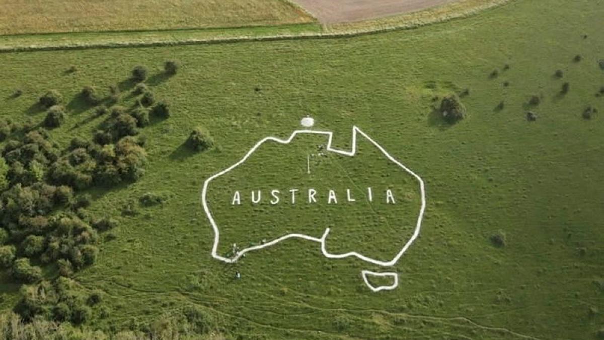 A chalk map of Australia cut into a green hillside.