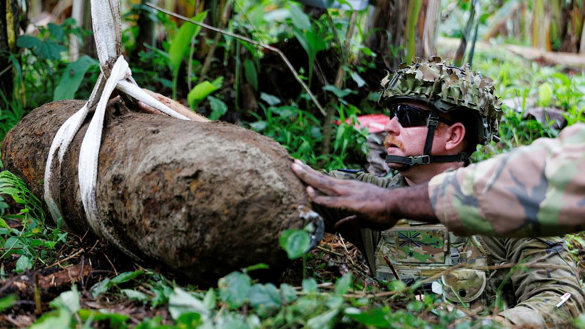Explosive Ordnance Technician, Australian Army Sergeant Philip Rutherford removes a 250lb bomb from a community in East New Britain, Papua New Guinea during Operation Render Safe.
