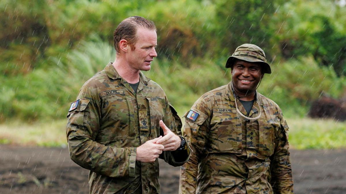 Australian Army Warrant Officer Mitchell Dolan (L) and Captain Adam Ampa'oi (R) deliver orders in East New Britain, Papua New Guinea on Operation Render Safe 26.