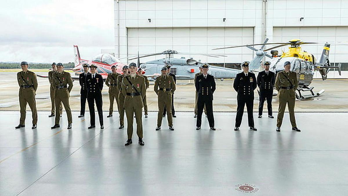 Army and Navy aviation professionals on parade in a hangar after the Joint Helicopter School graduation at HMAS Albatross.