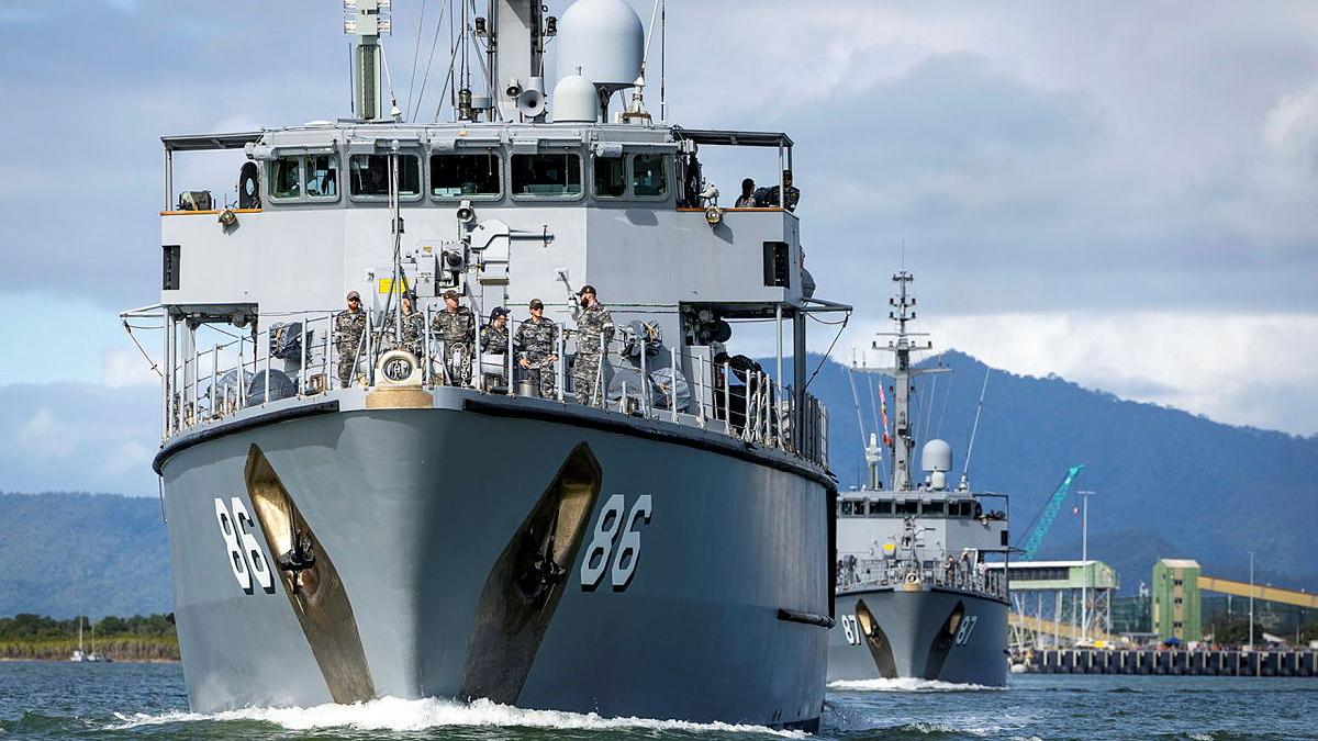 Two ships sail in a line.